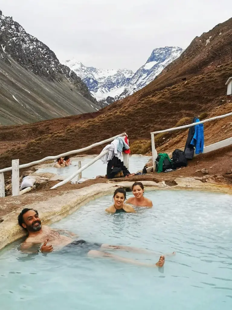 Grupo en las piscinas termales con la cordillera de los Andes de fondo