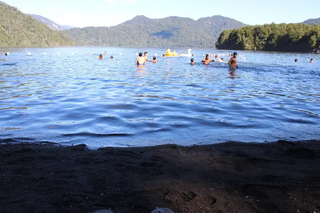 Lago Calafquén al atardecer con personas nadando, en la Región de la Araucanía
